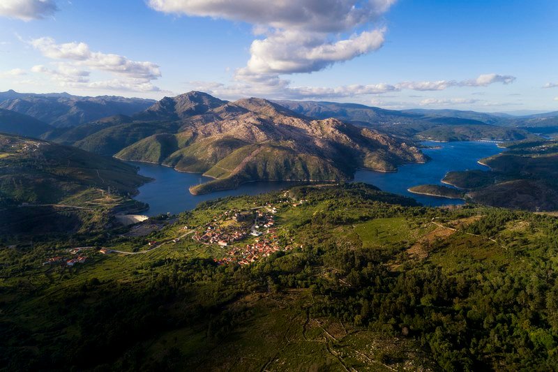 Aerial panoramic view of the historic village of Lindoso, with the surroundings mountains and lake, at the Peneda Geres National Park, in Portugal.